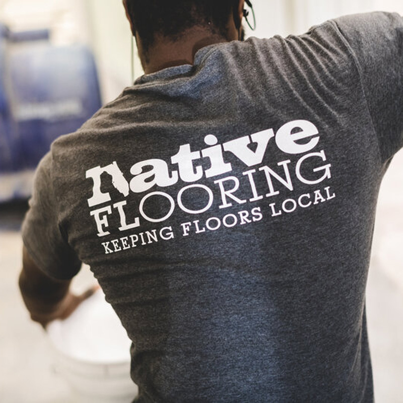 someone wearing a native flooring shirt