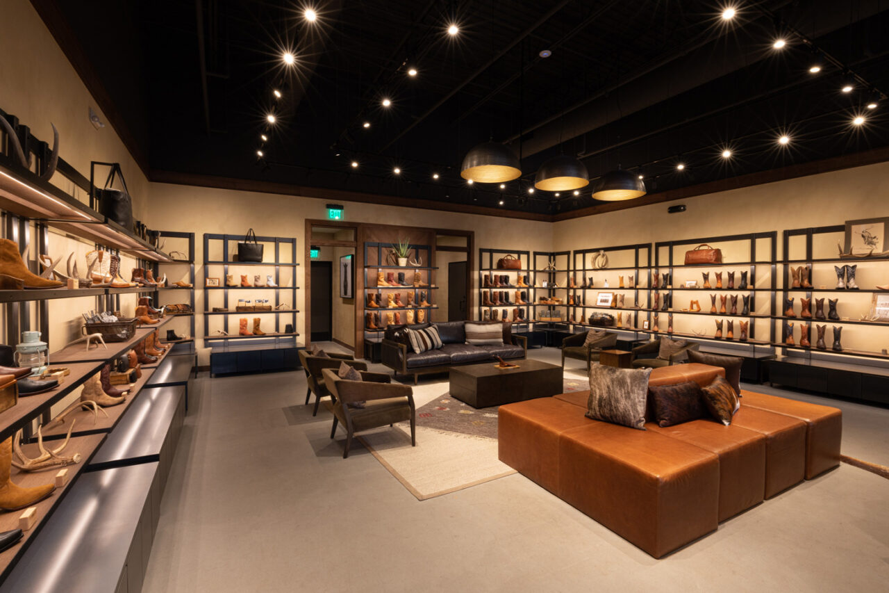 interior of a shoe shop with seating and shoes along the walls